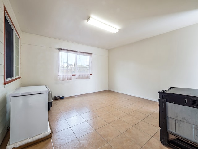 empty room with light tile patterned flooring