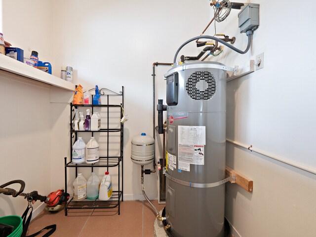 utility room featuring strapped water heater