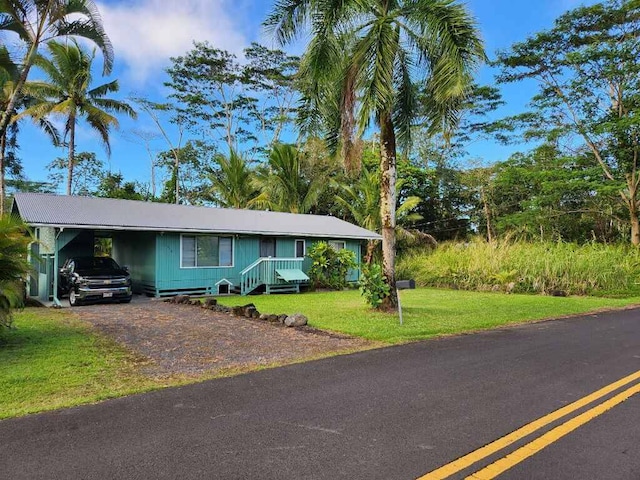 view of front of house with a front lawn and a carport