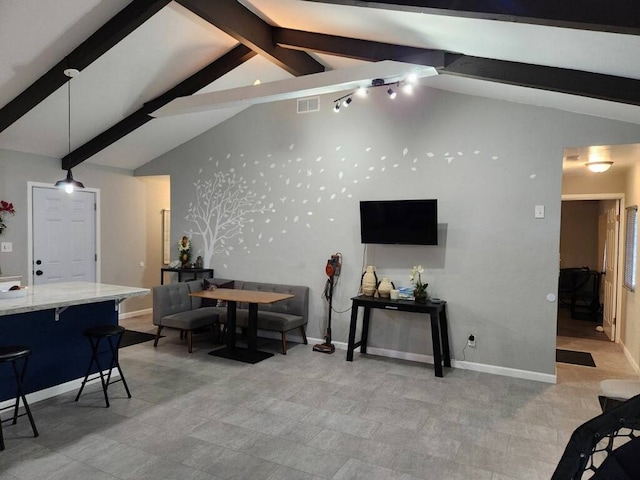 living room with lofted ceiling with beams