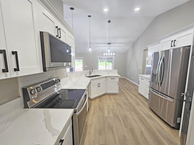 kitchen with light wood-type flooring, a sink, appliances with stainless steel finishes, and white cabinets