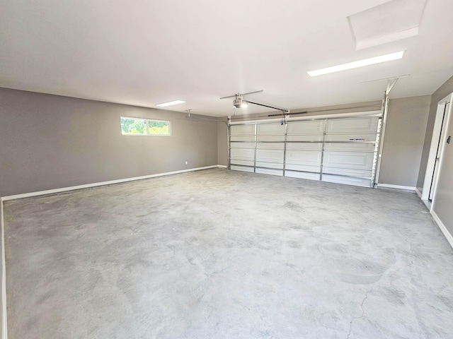 garage with baseboards and a garage door opener
