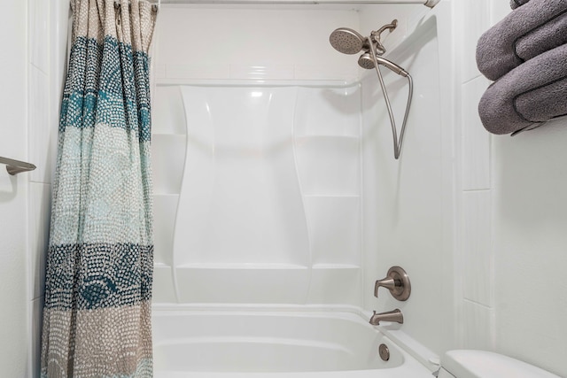 bathroom with shower / bath combo and toilet