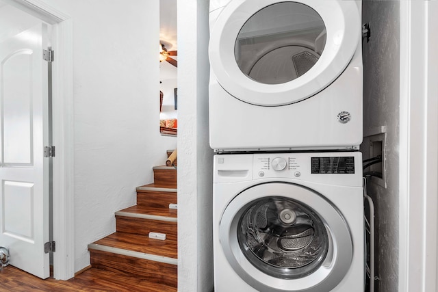 washroom with stacked washer / drying machine and dark hardwood / wood-style floors