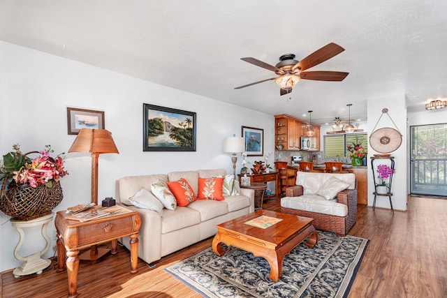 living room with light hardwood / wood-style flooring and ceiling fan