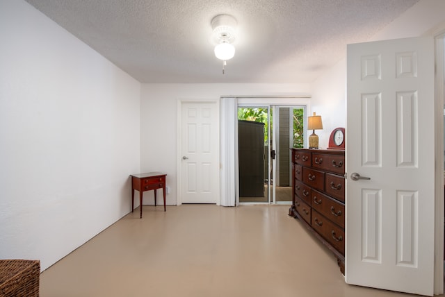 interior space with access to exterior and a textured ceiling