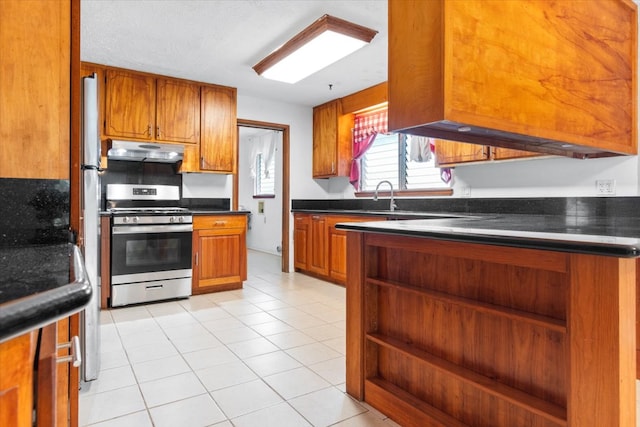 kitchen featuring sink, light tile patterned floors, and stainless steel appliances