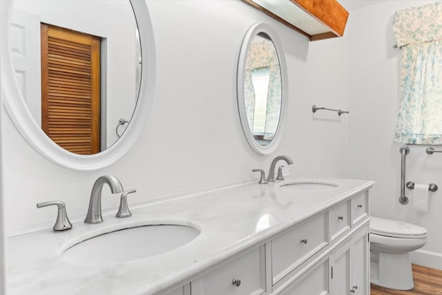 bathroom featuring hardwood / wood-style flooring, vanity, and toilet