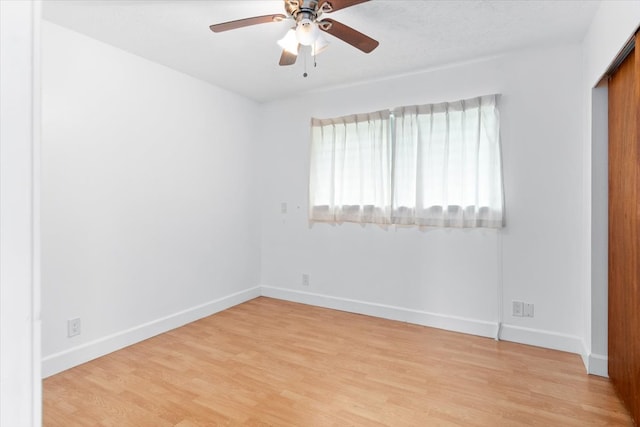 spare room with ceiling fan and light hardwood / wood-style floors