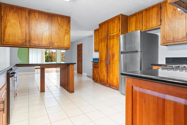 kitchen featuring light tile patterned floors and appliances with stainless steel finishes