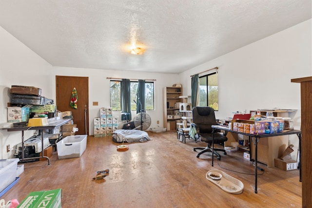 home office featuring wood-type flooring and a textured ceiling