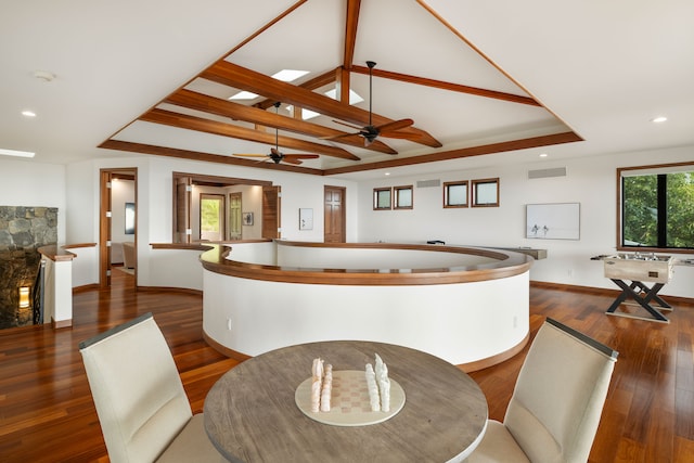 dining area with ceiling fan, a raised ceiling, and dark hardwood / wood-style flooring