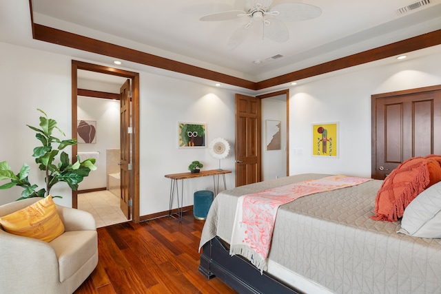 bedroom featuring connected bathroom, dark hardwood / wood-style flooring, and ceiling fan