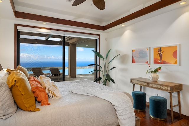 bedroom featuring access to outside, hardwood / wood-style flooring, multiple windows, and a water view