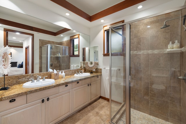 bathroom with vanity, a raised ceiling, and a shower with shower door