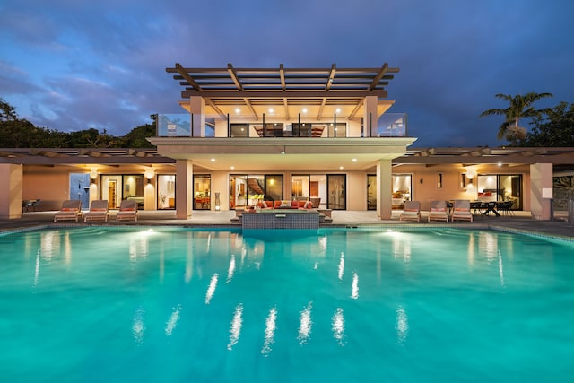 view of swimming pool with an outdoor hangout area, a patio, and a pergola