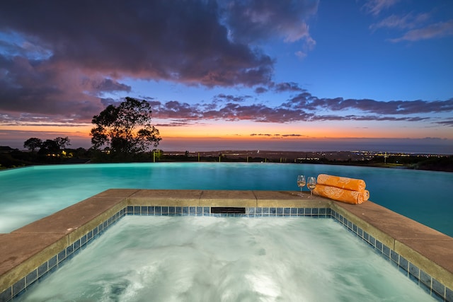 pool at dusk with a water view