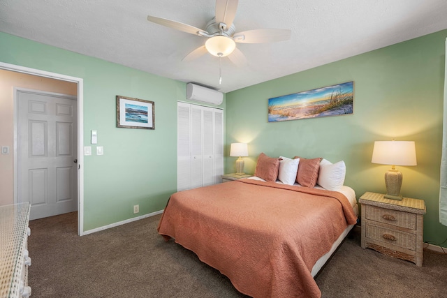 carpeted bedroom with a closet, a wall mounted AC, and ceiling fan