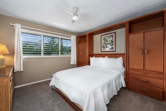 carpeted bedroom featuring ceiling fan and a textured ceiling