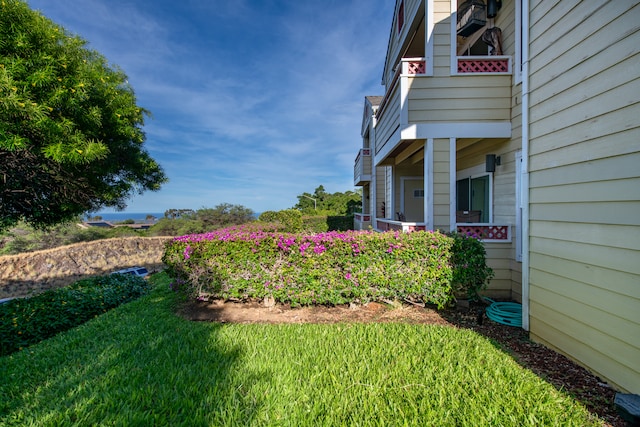 view of yard with a balcony