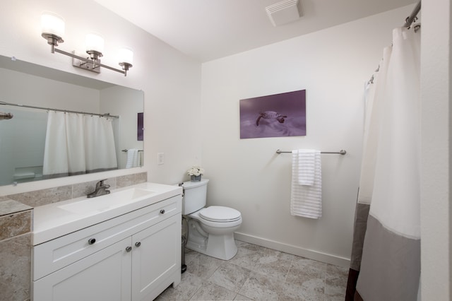 bathroom featuring walk in shower, vanity, and toilet