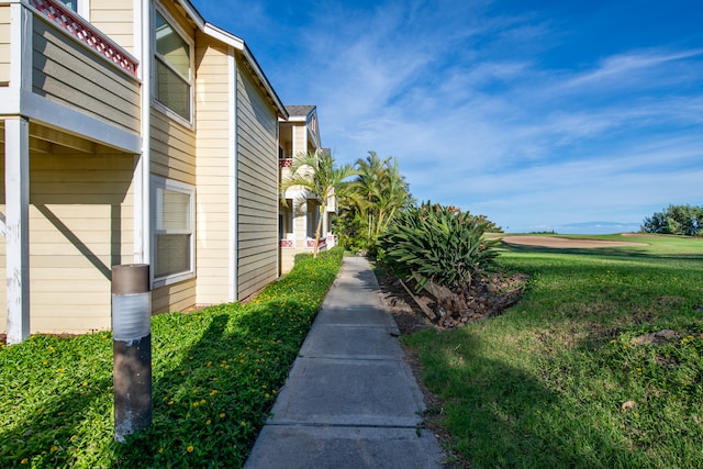 view of side of property with a lawn