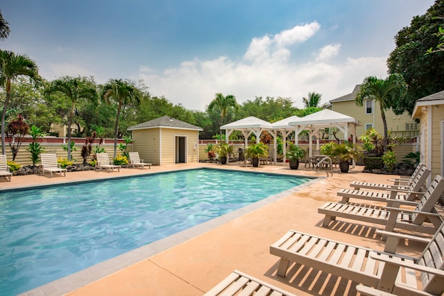 view of swimming pool featuring an outdoor structure, a gazebo, and a patio