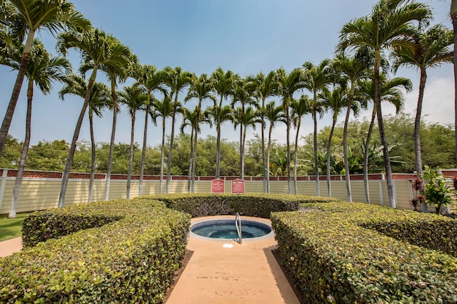 view of pool with a hot tub