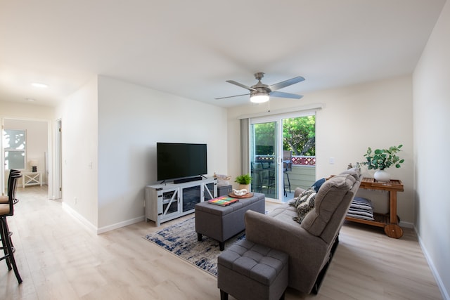 living room featuring light wood-type flooring and ceiling fan