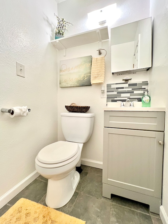 bathroom with vanity, tile patterned floors, toilet, and backsplash