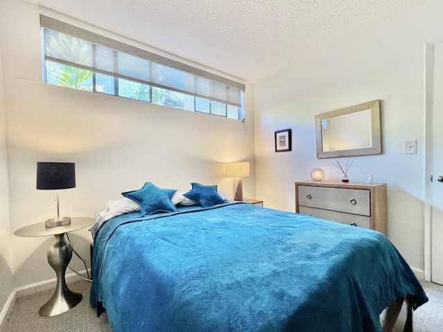 carpeted bedroom with a textured ceiling