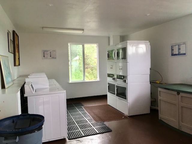 laundry room with stacked washer and clothes dryer and washing machine and clothes dryer