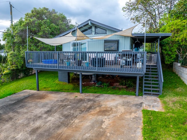 rear view of property with a yard and a deck