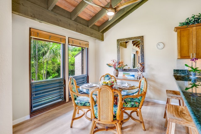 dining area featuring ceiling fan, vaulted ceiling with beams, light hardwood / wood-style floors, and wooden ceiling