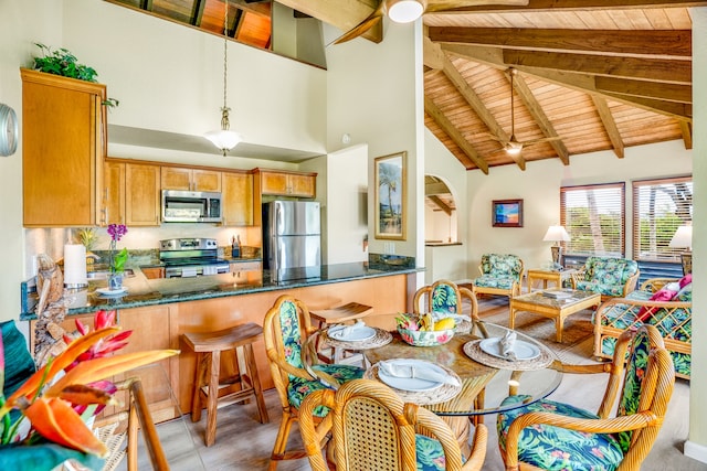 dining room with high vaulted ceiling, wooden ceiling, and beamed ceiling