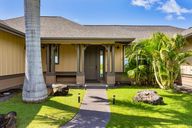 entrance to property with a lawn