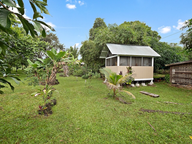 view of yard with a sunroom