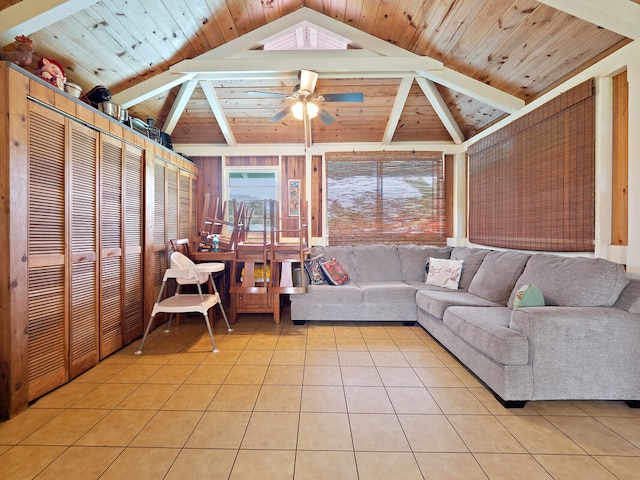 living room featuring ceiling fan, vaulted ceiling with beams, and light tile patterned floors