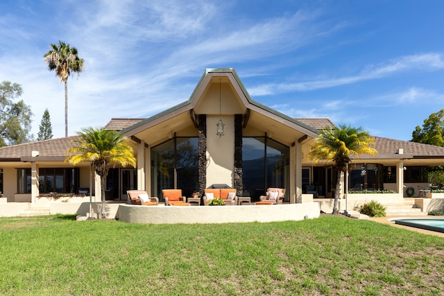 back of house with a yard and a patio