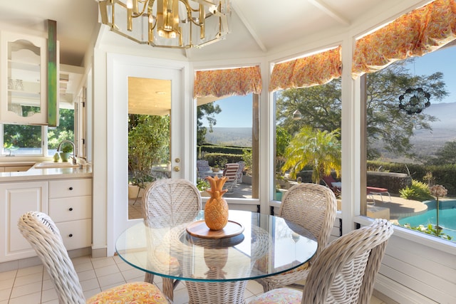 sunroom with sink and a notable chandelier