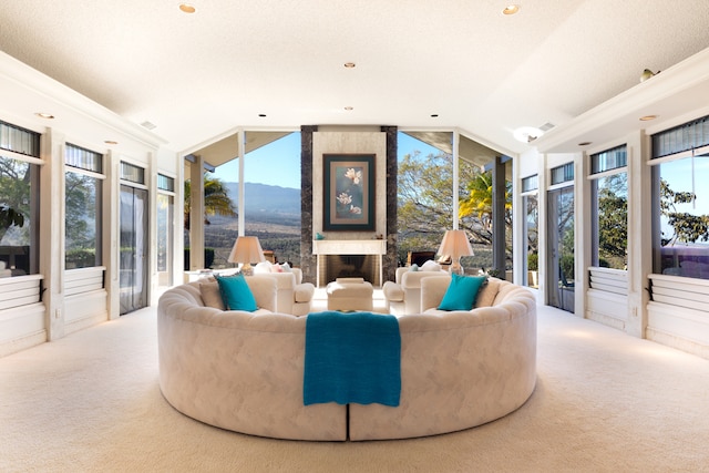 living room featuring lofted ceiling, a mountain view, carpet floors, and ornamental molding