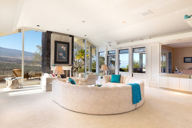 carpeted living room featuring a mountain view and lofted ceiling