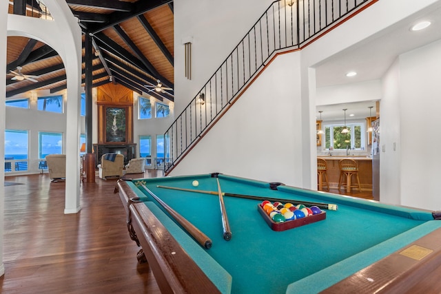 recreation room featuring beamed ceiling, wood ceiling, dark hardwood / wood-style floors, and high vaulted ceiling