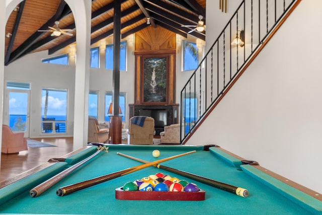 recreation room featuring beamed ceiling, hardwood / wood-style floors, high vaulted ceiling, and wooden ceiling