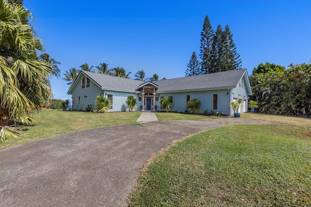 ranch-style home featuring a front lawn and a garage