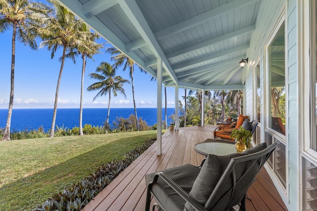 deck featuring a lawn and a water view