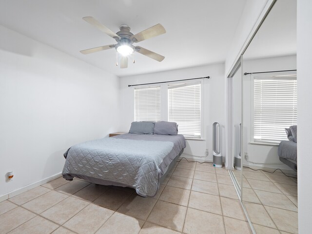 tiled bedroom featuring ceiling fan