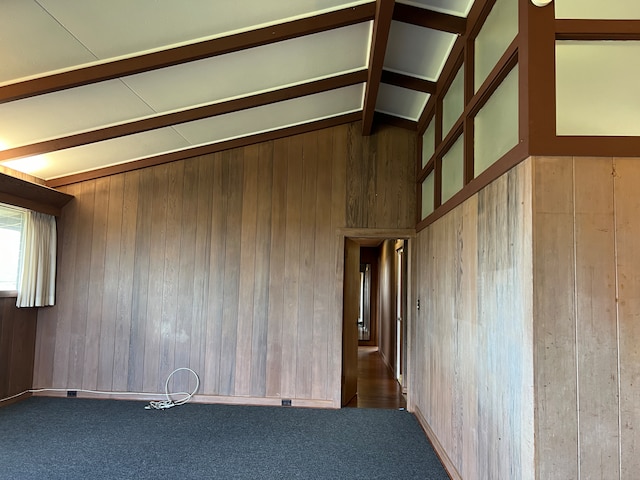 staircase featuring wooden walls and a textured ceiling