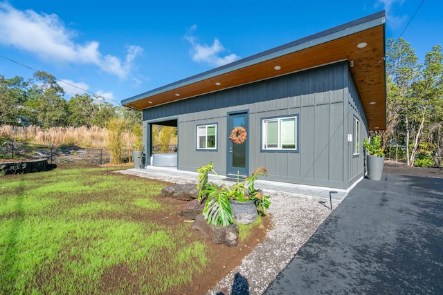 back of property featuring a lawn and a patio area