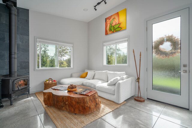 living room featuring a wood stove and concrete floors